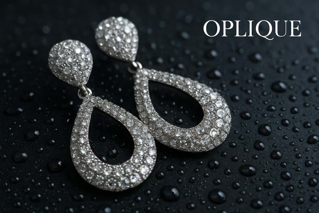 Elegant pair of earrings glistening with water droplets, Oplique logo overlayed in the top-right corner: Pair of luxury earrings with water droplets