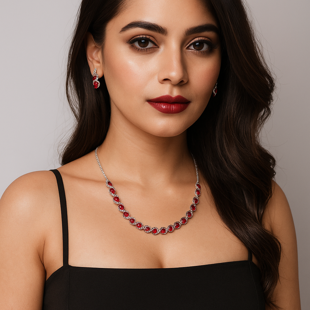 Woman wearing a red and silver necklace with a plain background. Brand: Oplique By Vineeta