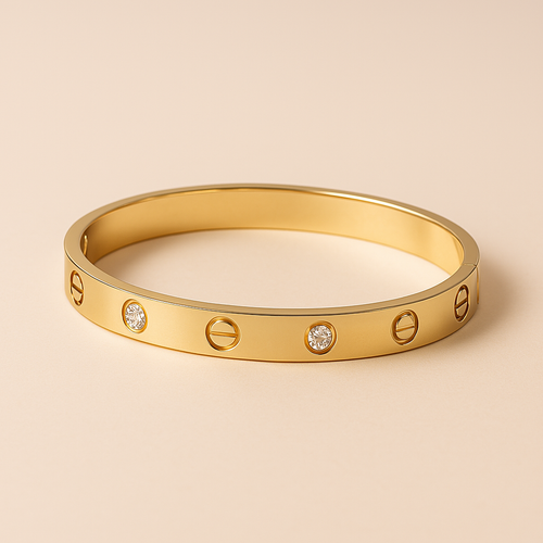 Gold bracelet with diamond accents on a beige background. Oplique By Vineeta