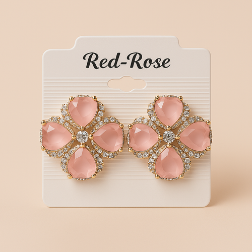 Pair of pink floral earrings on a Red-Rose branded card against a beige background. Oplique By Vineeta