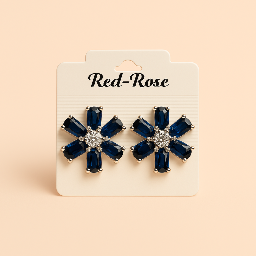 Pair of blue flower-shaped earrings on a Red-Rose branded card against a beige background