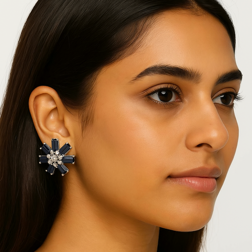 Woman wearing a blue floral earring on a plain background Oplique By Vineeta