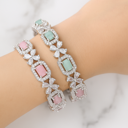Two elegant bracelets with gemstones on a white background. Brand: Oplique By Vineeta