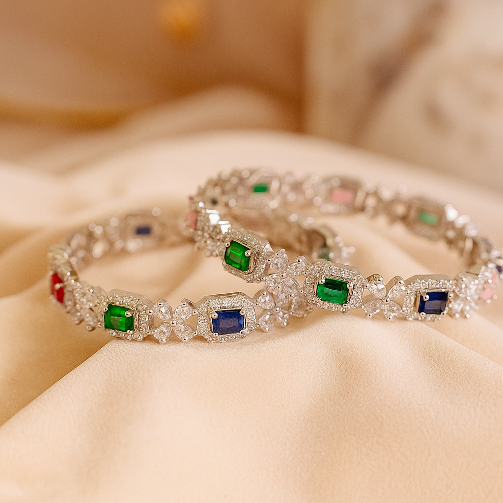 Silver bracelet with colorful gemstones on a beige fabric background. Brand: Oplique By Vineeta