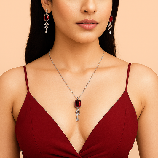 A Woman wearing a red dress with a necklace and earrings on a beige background. Brand: Oplique By Vineeta