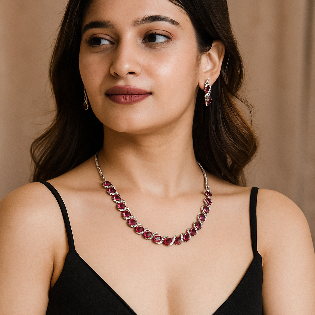 Woman wearing a red gemstone necklace and earrings against a beige background. Brand: Oplique By Vineeta