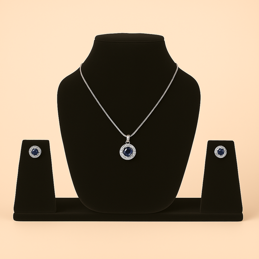 Jewelry set with necklace and earrings on a black stand against a beige. Brand: oplique By Vineeta background